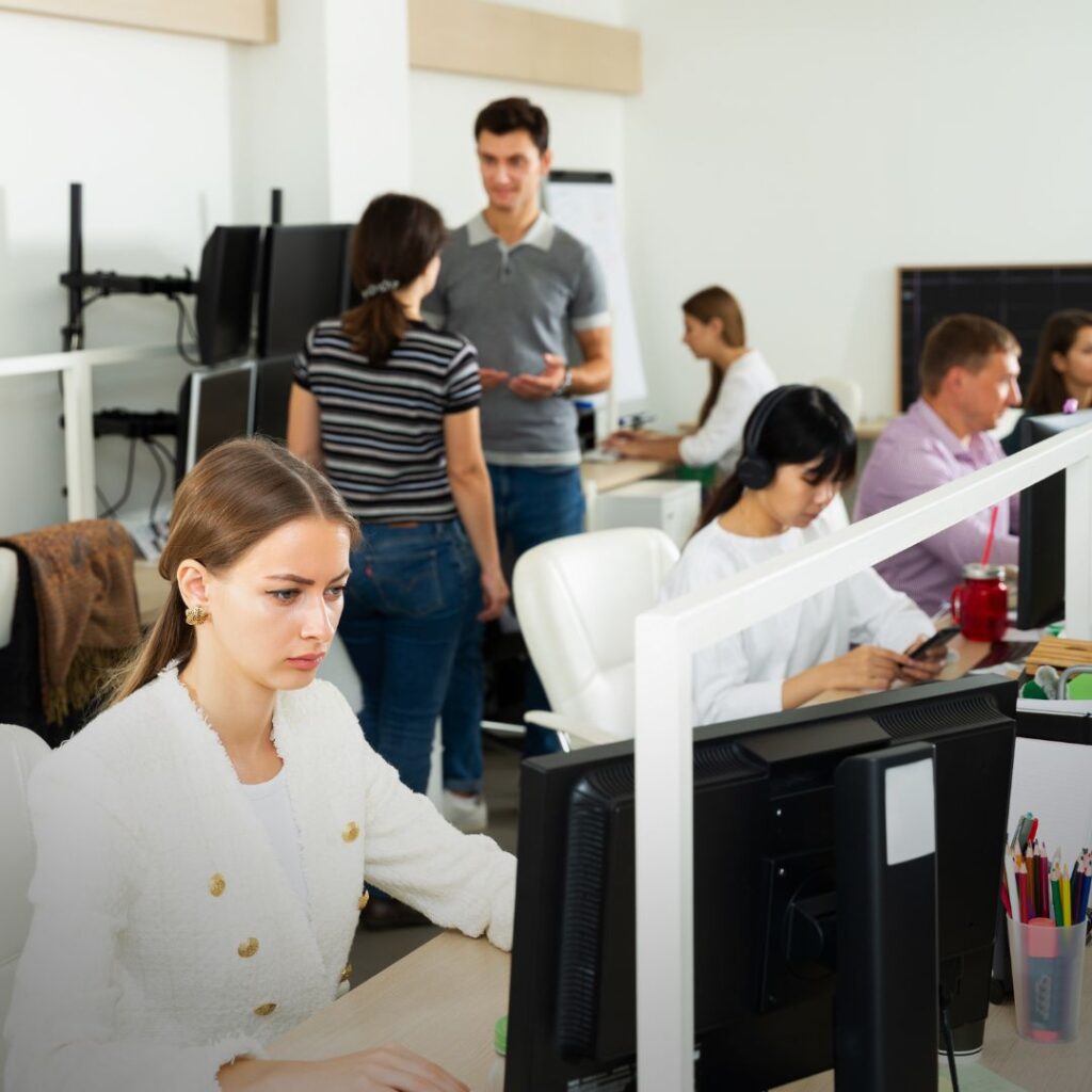 Autistic employee at desk in Hong Kong office, representing workplace masking